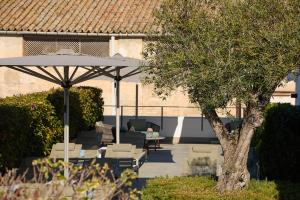 a patio with an umbrella and a table and chairs at Sant Jaume Design Hotel in Palma de Mallorca