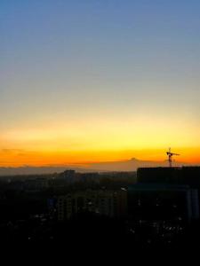 a sunset with a cross on top of a city at Bohemian Studio Home in Nairobi Kilimani in Nairobi