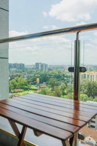 a window in a building with a wooden bench at Bohemian Studio Home in Nairobi Kilimani in Nairobi