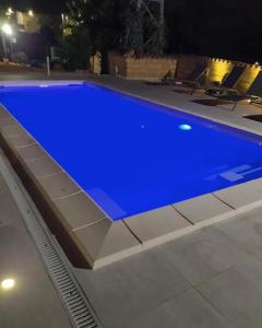 a large blue swimming pool at night at Villa Lory in Agrigento