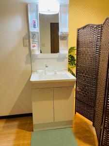 a bathroom with a sink and a mirror at 難波心斎橋10 minutes民宿3号室 in Osaka