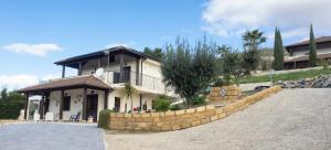 a house with a stone wall in front of it at Villa Lory in Agrigento