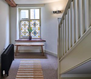 a stairway with a bench and a window at Studio 2 - Central Location Sleeps 4 in Norwich