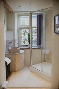 a bathroom with a glass shower and a sink at Studio 2 - Central Location Sleeps 4 in Norwich