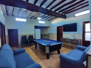 a living room with a pool table and a tv at Casa Rural Serrano in Abrucena