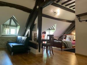 a living room with a bed and a couch and a chair at Appartement Héritage - 1 chambre 4 personnes in Hargeville