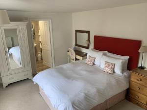 a bedroom with a large white bed with two pillows at The Heritage Bed and Breakfast in Weymouth