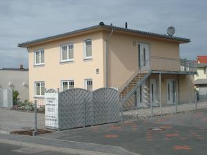 ein Haus mit einem Zaun davor in der Unterkunft Zinnowitz-Ambiente in Zinnowitz