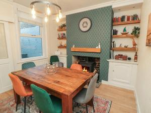 a dining room with a table and chairs and a fireplace at Bay House in Bridlington