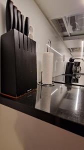 a counter in a kitchen with a counter top at Riverside apartment with french balcony in Turku