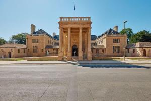 a building with a tower in the middle of a street at Rhodes House, Oxford in Oxford +8 photos