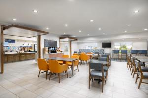 a restaurant with tables and chairs and a counter at Holiday Inn Express Las Vegas Stadium Area, an IHG Hotel in Las Vegas