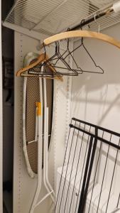 a closet with white utensils on a shelf at Home away near services in Turku