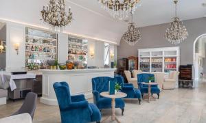 a bar with blue chairs and tables in a room at Aminess Younique Korcula Heritage Hotel in Korčula