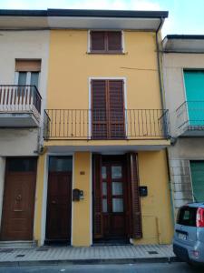 a yellow building with two doors and a balcony at Vacanze Versilia in Viareggio