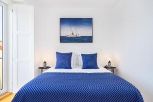 a bedroom with a bed with a sailboat in the water at WHome Beato Premium River View in Quiet Area in Lisbon