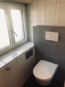 a bathroom with a white toilet and a window at Studio near Lake in Zürich