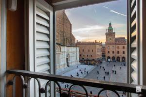 a view of a city street from a window at Urbanicooh Asinelli - Balcony on Piazza Maggiore in Bologna