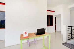 een bureau met een laptop op de kamer bij SUPER OYO 3702 Homestay Bougenville Syariah in Lamongan