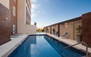 a swimming pool on the side of a building at Home2 Suites By Hilton Winter Garden in Orlando