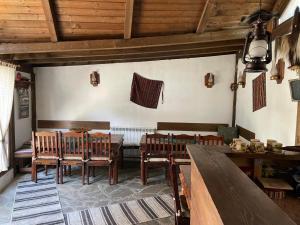 a dining room with wooden tables and chairs at Kalaidjievi in Bansko