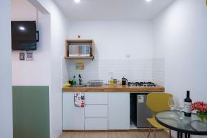 a small kitchen with a counter and a table at Casa Samaykuy in Ayacucho