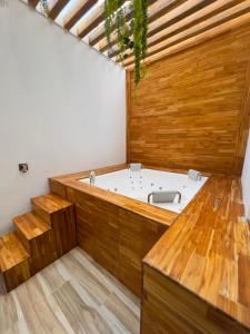a jacuzzi tub in a room with wood at Hotel Dorado Plaza Alto Prado in Barranquilla