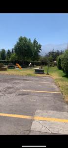 an empty parking lot with a park in the background at Arriendo Departamento in Santiago
