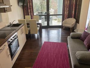 a kitchen and living room with a couch and a table at Ferienwohnung Pension am Weinberg in Mainstockheim