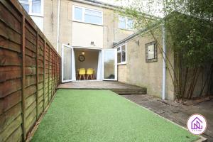 a house with a green lawn in front of it at Blagdon Park, Stylish house in Bath, Free parking in Bath
