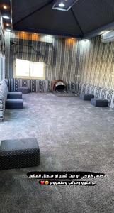 a room with a bunch of chairs and a fireplace at شاليه أمي لولوة in Az Zulfi