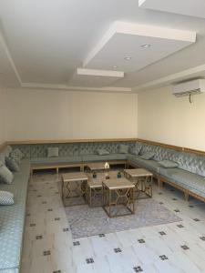 a waiting room with couches and tables in a building at شاليه أمي لولوة in Az Zulfi