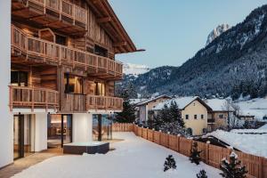 a house in the mountains with snow on the ground at Chalet Milé in Ortisei