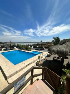 a swimming pool in a yard with a fence at Cabañas las Balsas Rapel in Las Cabras