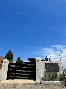 a sign for a restaurant in front of a building at Cabañas las Balsas Rapel in Las Cabras