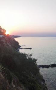 a view of a body of water at sunset at Koralli Sea View Hotel in Kato Achaia
