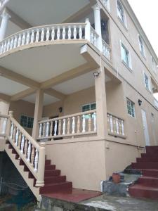 a house with a staircase in front of it at Ark Royal of the Caribbean in Kingstown