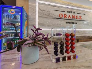 a potted plant in a vase next to a vending machine at Orange Business Hotel Petaling Jaya in Petaling Jaya