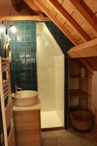 a bathroom with a sink and a tub in a room at LA LONGERE GALOPE in Sainte-Gauburge-Sainte-Colombe