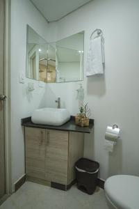 a bathroom with a sink and a mirror at FLORA New & beautiful studio apartment with rooftop in Cali