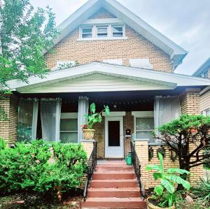 a brick house with a staircase leading to the front door at Perfect! near CLE Clinic/Case/UH/Downtown! in Cleveland