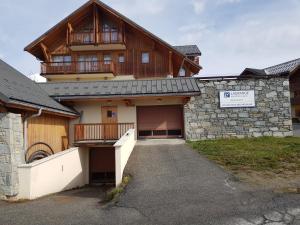 a large house with a balcony on top of it at Les balcons des aiguilles in La Toussuire