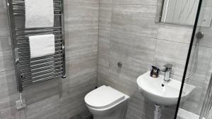 uma casa de banho com um WC branco e um lavatório. em Romance On The Rows - Hot Tub City Centre em Chester