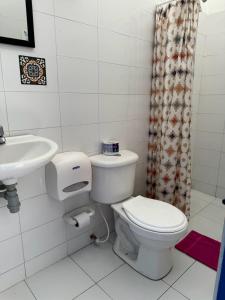 a bathroom with a toilet and a sink at Hostal 1811 in Cartagena de Indias