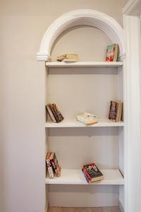 a shelf in a hallway with books at Dimitra Apartment in Kassiopi