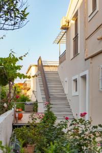 a staircase leading up to a building with pink flowers at Dimitra Apartment in Kassiopi