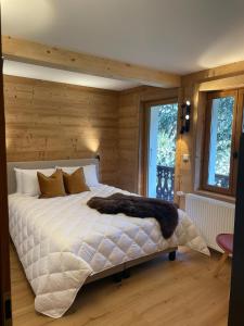 a bedroom with a large bed with wooden walls at Chalet Yuki in Morzine