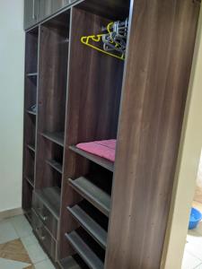 a wooden closet with stairs in it at Tommy's Budget Rooms in Kigali