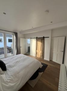 a bedroom with a large white bed and a window at The Bunga, Portrush in Portrush