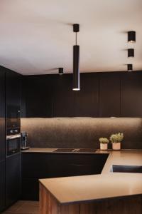 a kitchen with black cabinets and a counter top at Luxury Chalet Milé in Ortisei +93 photos